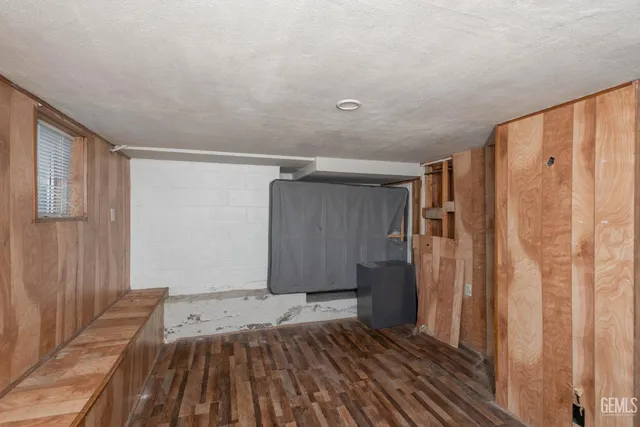 a view of a room with wooden floor and a window
