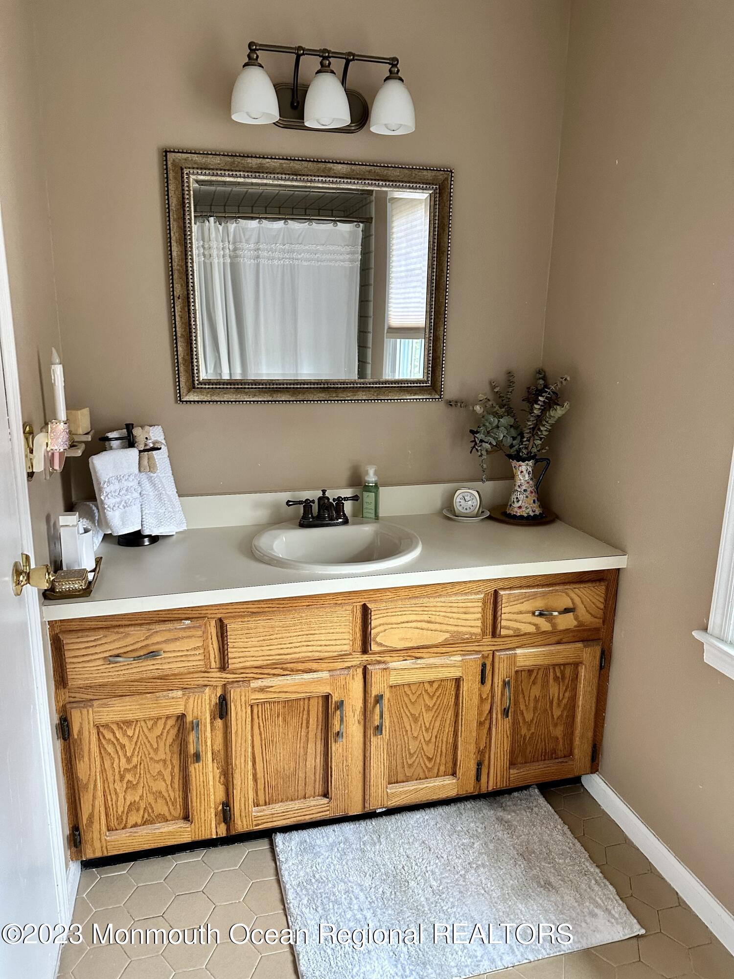 12 Spicy Pond Road Howell, NJ 07731 - Photo 12 of 19 a bathroom with a sink and a mirror
