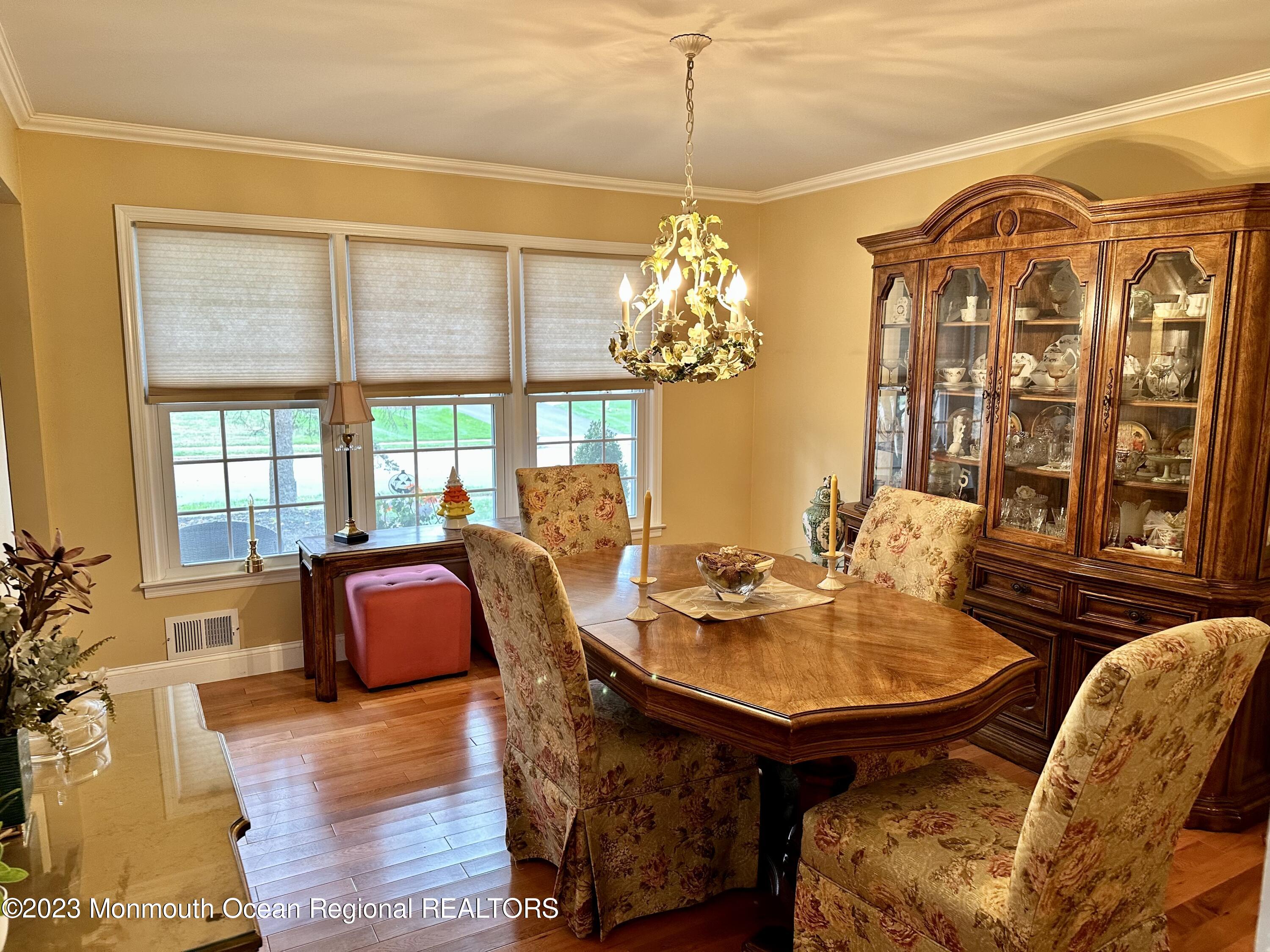 12 Spicy Pond Road Howell, NJ 07731 - Photo 7 of 19 a view of a dining room with furniture a chandelier and wooden floor