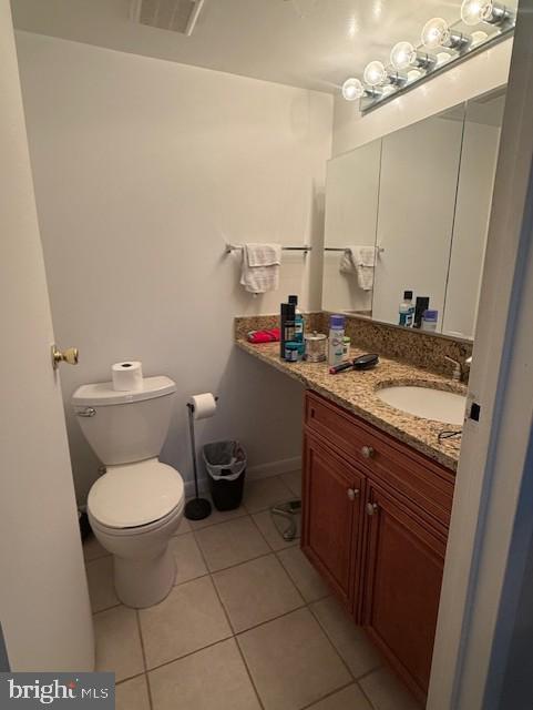 11260 Chestnut Grove Square, Unit 338 Reston, VA 20190 - Photo 12 of 18 a bathroom with a granite countertop toilet and a sink