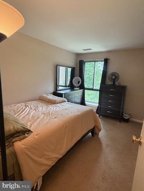 11260 Chestnut Grove Square, Unit 338 Reston, VA 20190 - Photo 14 of 18 a bedroom with a bed and a dresser