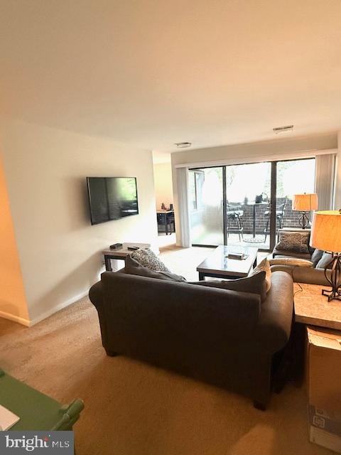 11260 Chestnut Grove Square, Unit 338 Reston, VA 20190 - Photo 3 of 18 a living room with furniture and a flat screen tv