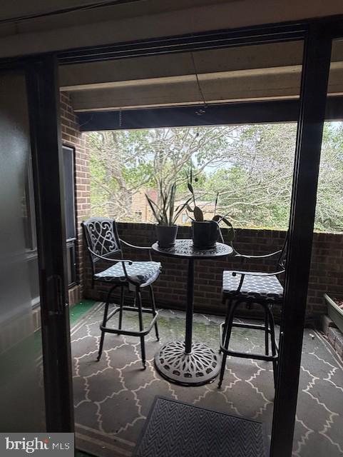 11260 Chestnut Grove Square, Unit 338 Reston, VA 20190 - Photo 4 of 18 a view of a chairs and table in the window