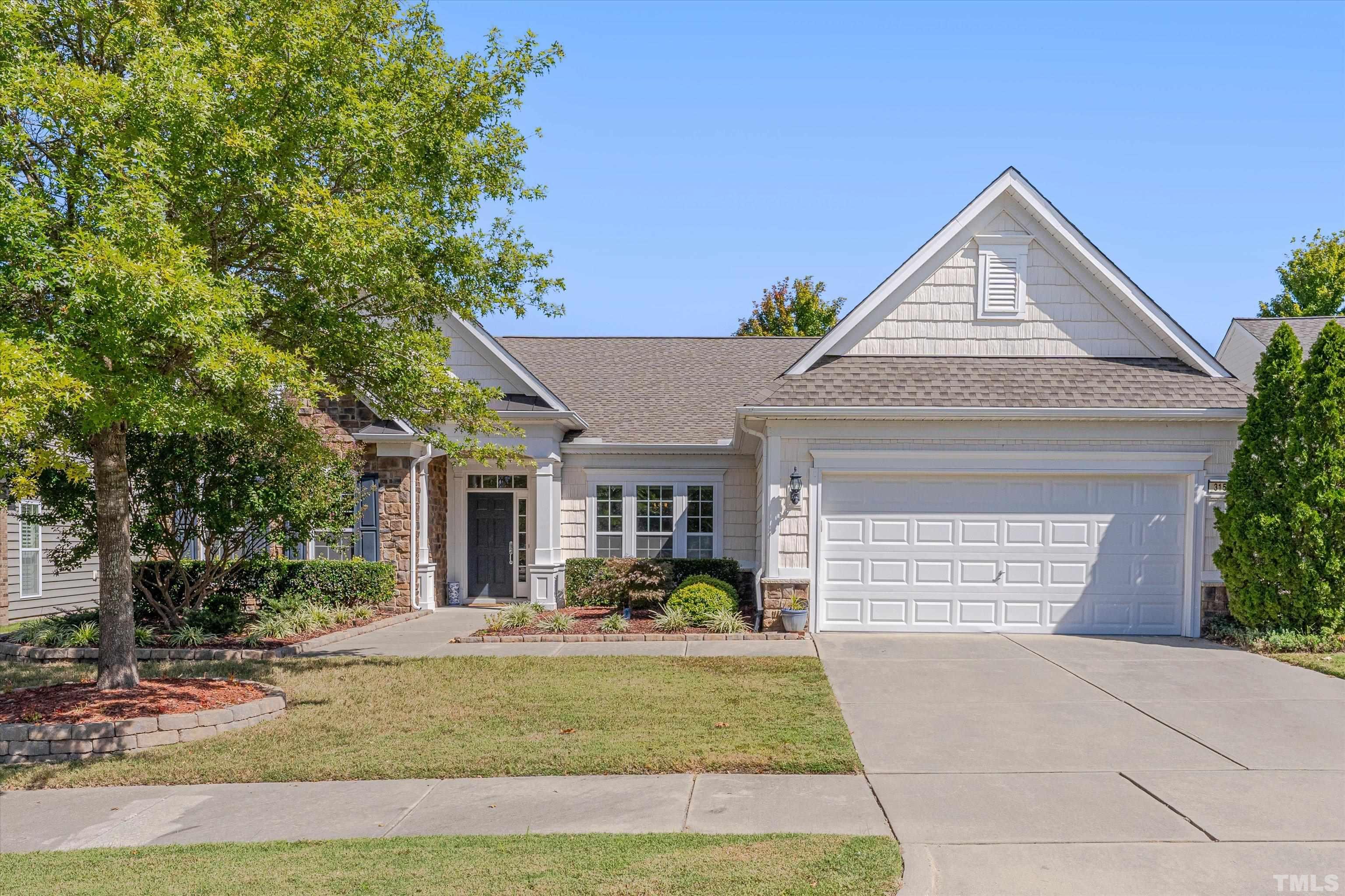 a view of a house with a yard and plants