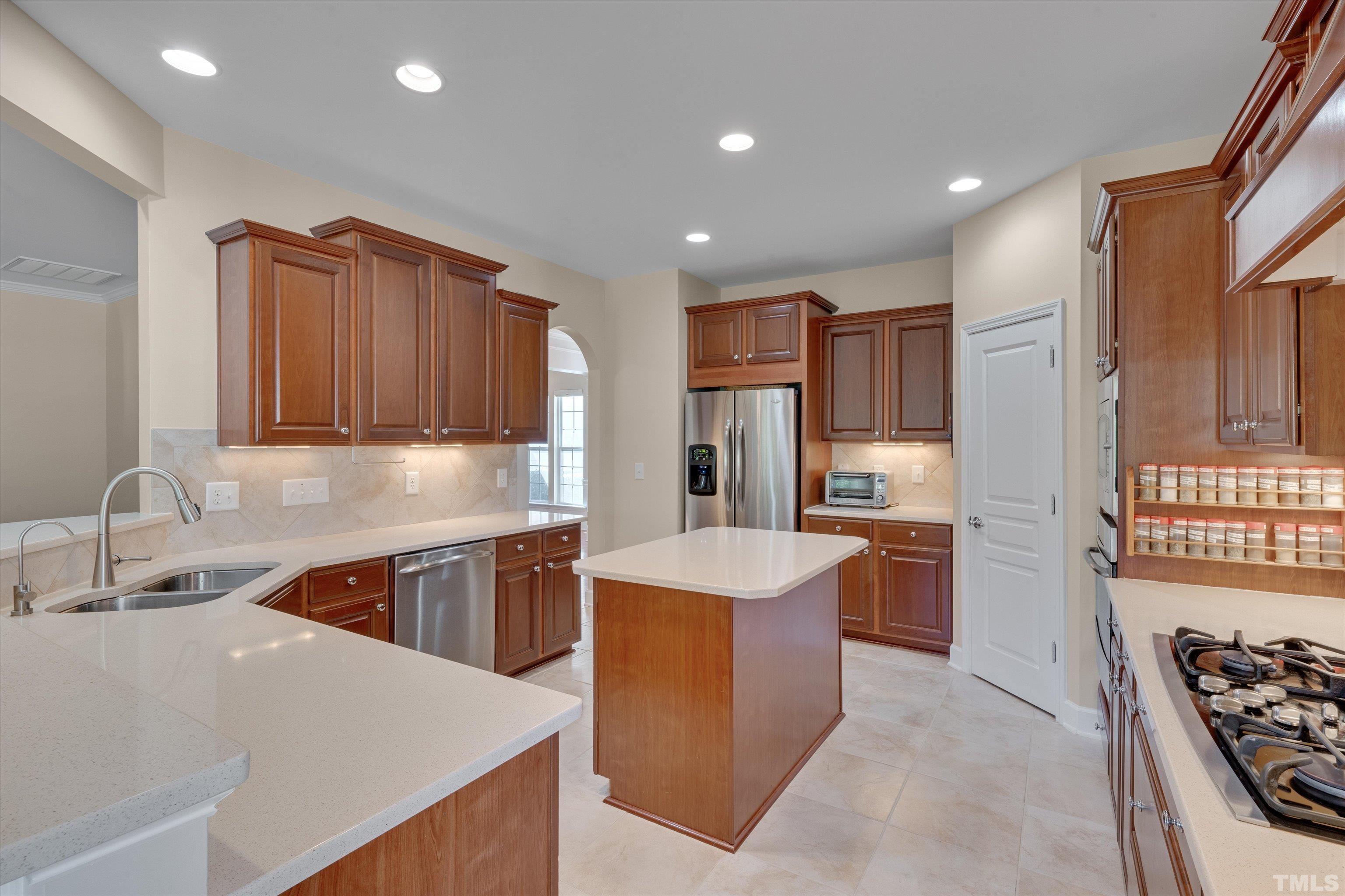 315 Beckingham Loop Cary, NC 27519 - Photo 16 of 34 a kitchen with stainless steel appliances granite countertop a sink stove and refrigerator