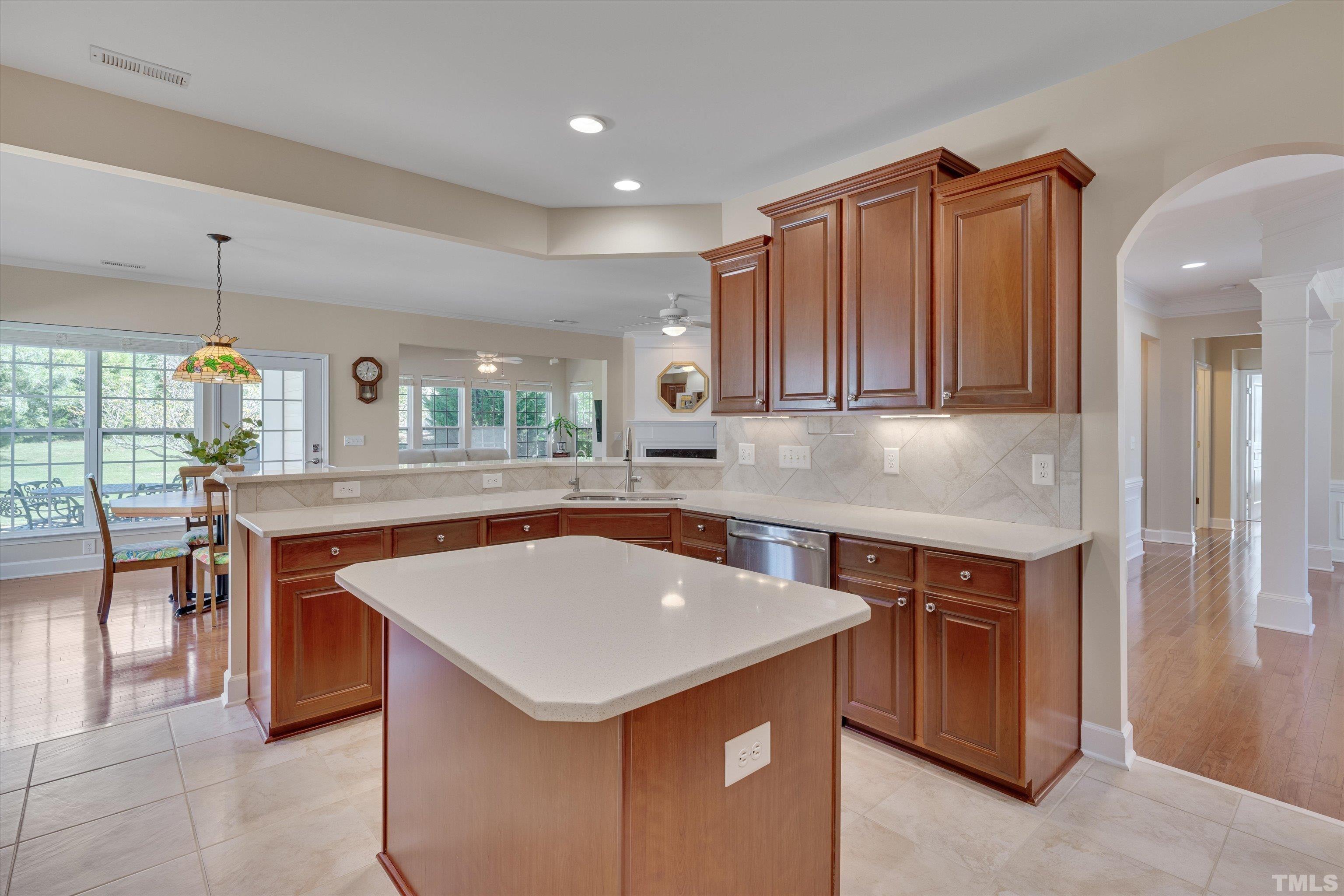 315 Beckingham Loop Cary, NC 27519 - Photo 17 of 34 a kitchen with a stove a sink a microwave a dining table and chairs