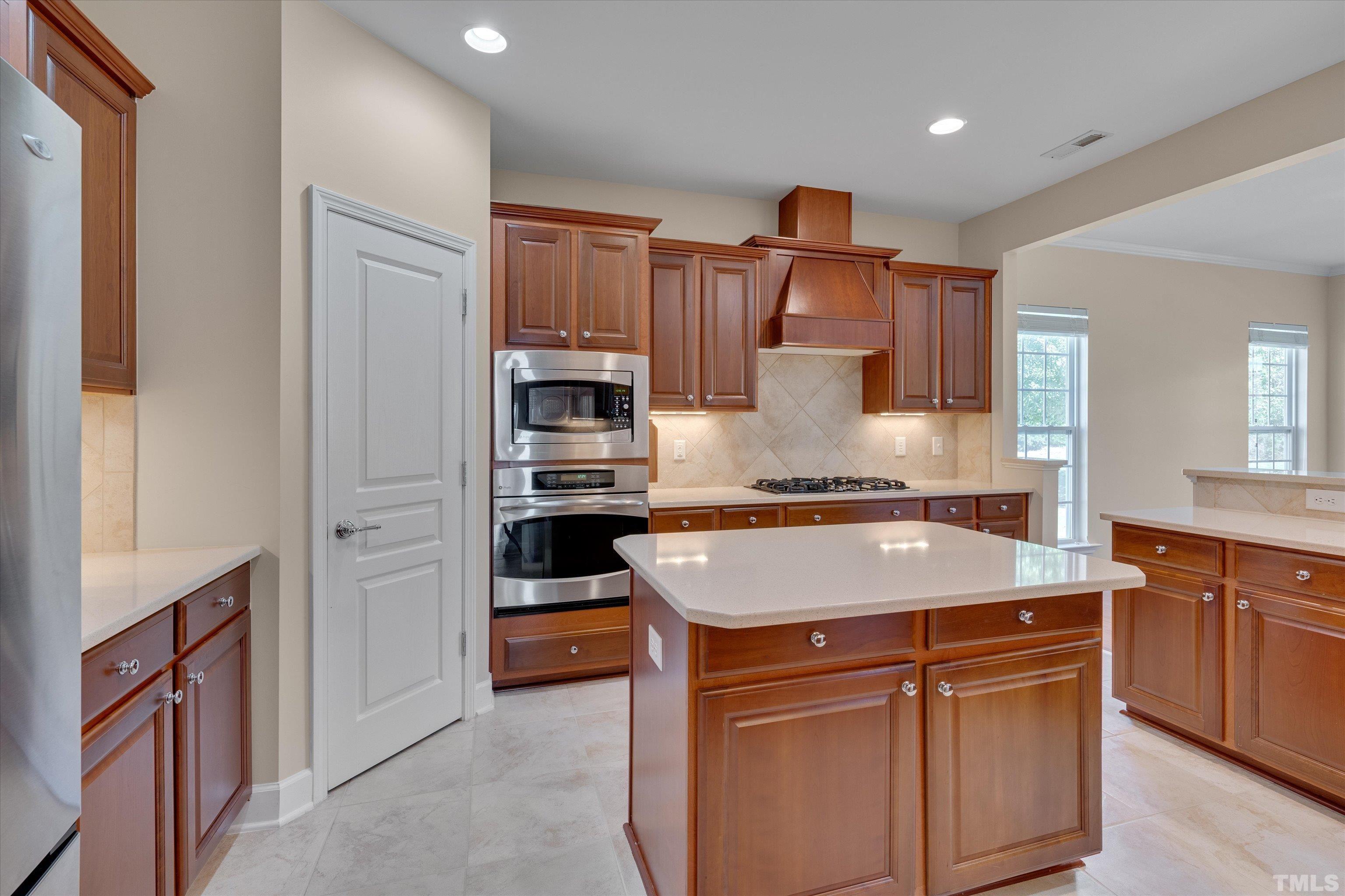 315 Beckingham Loop Cary, NC 27519 - Photo 18 of 34 a kitchen with stainless steel appliances granite countertop a sink stove and refrigerator