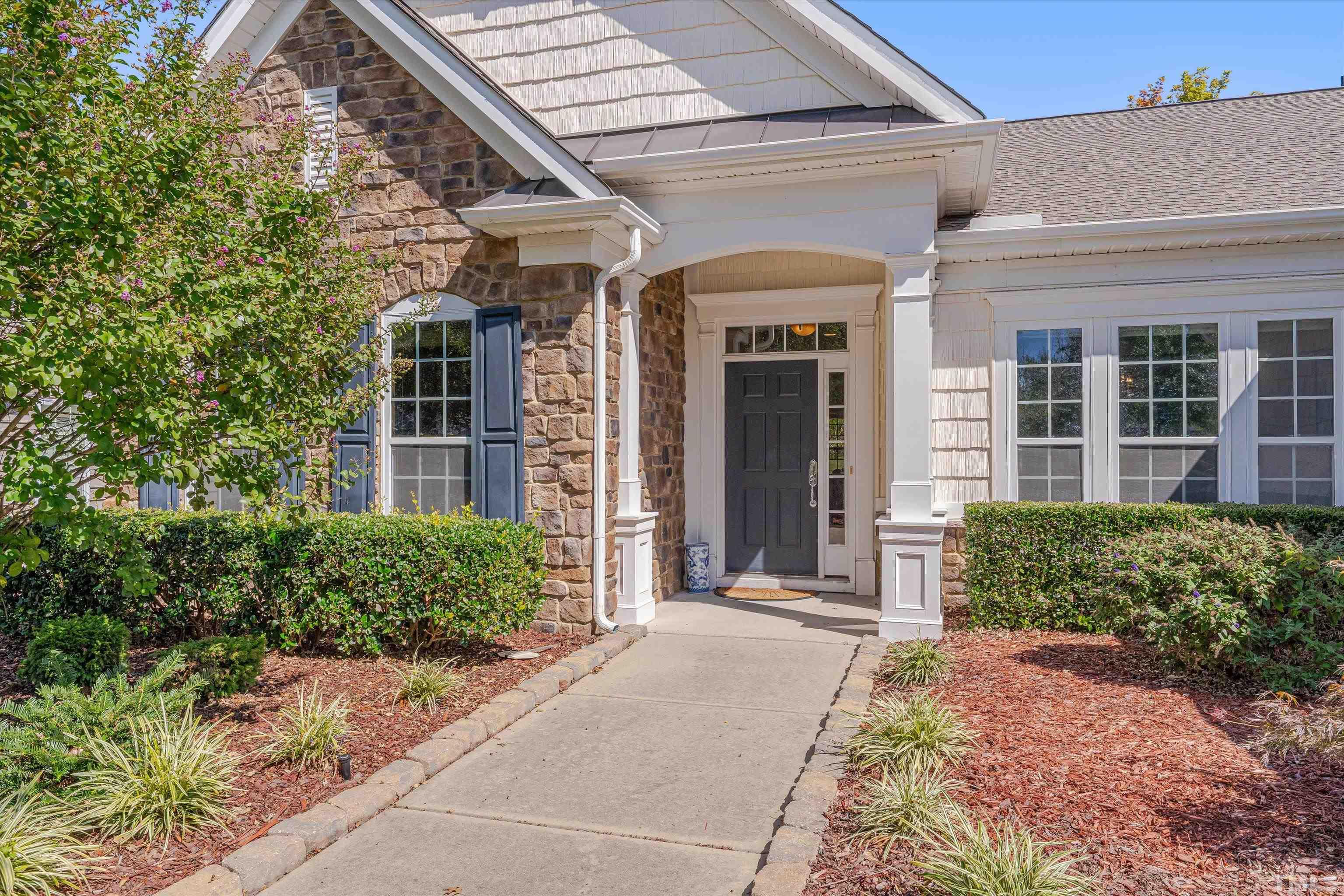 315 Beckingham Loop Cary, NC 27519 - Photo 2 of 34 front view of a brick house with a large window