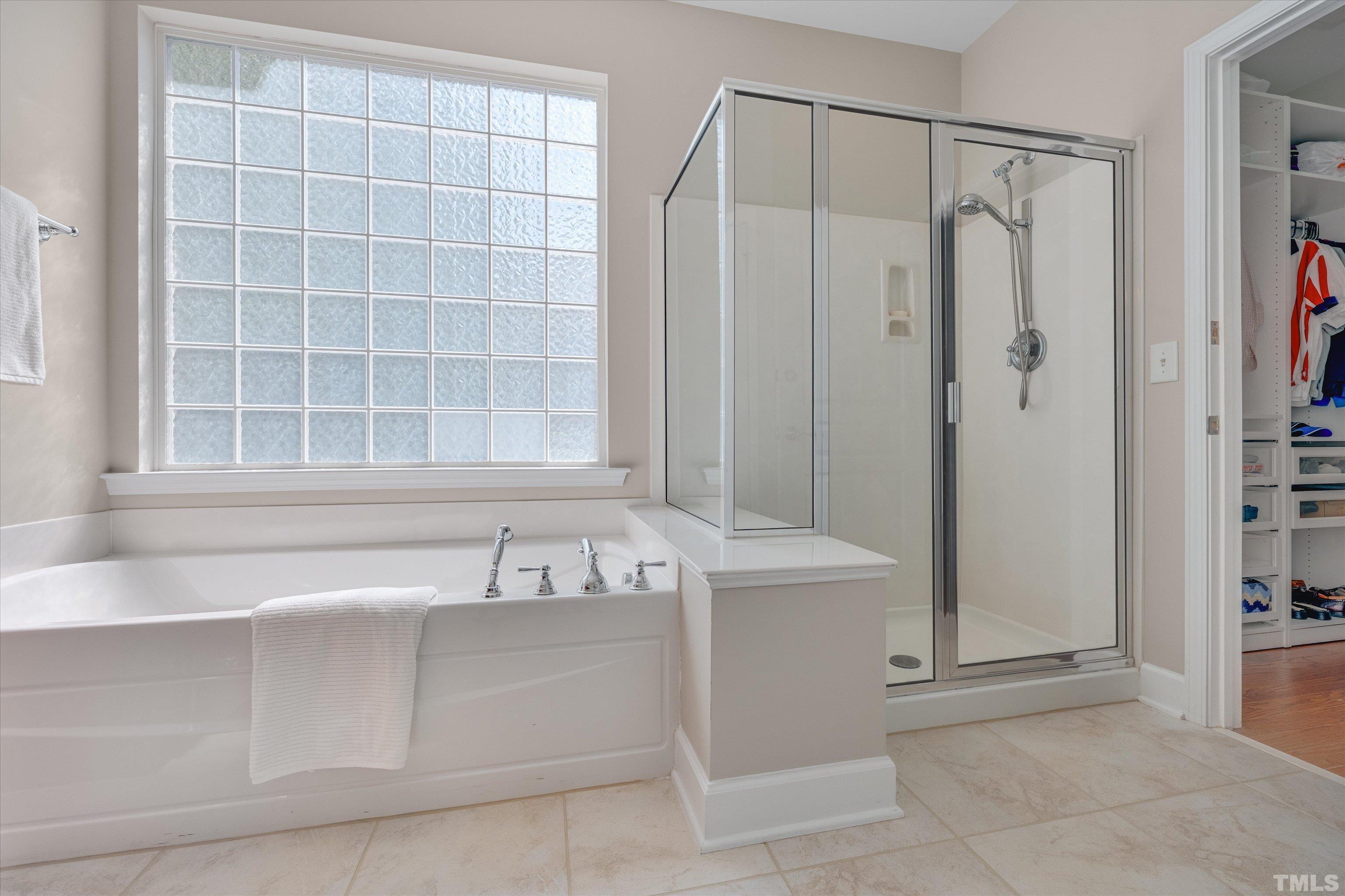 315 Beckingham Loop Cary, NC 27519 - Photo 22 of 34 a bathroom with a bathtub and a shower