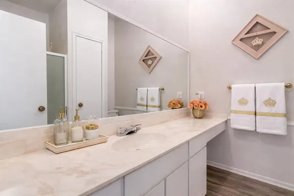a bathroom with a granite countertop sink and a mirror