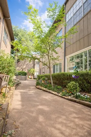 a view of a garden with a building in the background