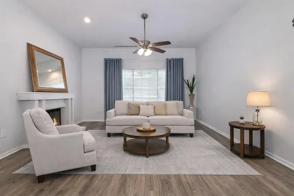 a living room with furniture a fireplace and a chandelier