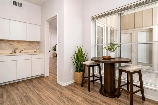 a kitchen with a table and chairs in it