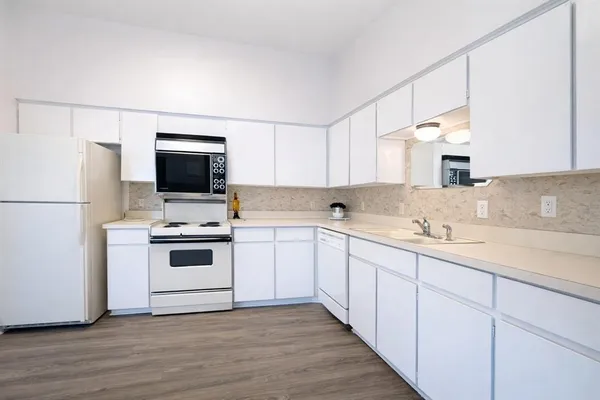 a kitchen with a sink appliances and cabinets