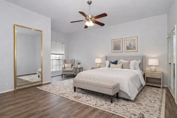 a bedroom with a large bed and a window