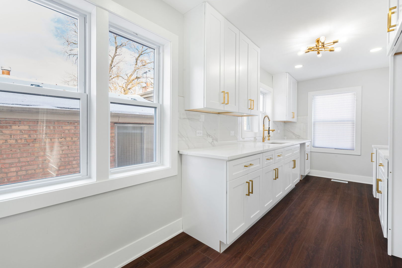 9633 South Yale Avenue Chicago, IL 60628 - Photo 11 of 26 a kitchen with a white cabinets and wooden floor