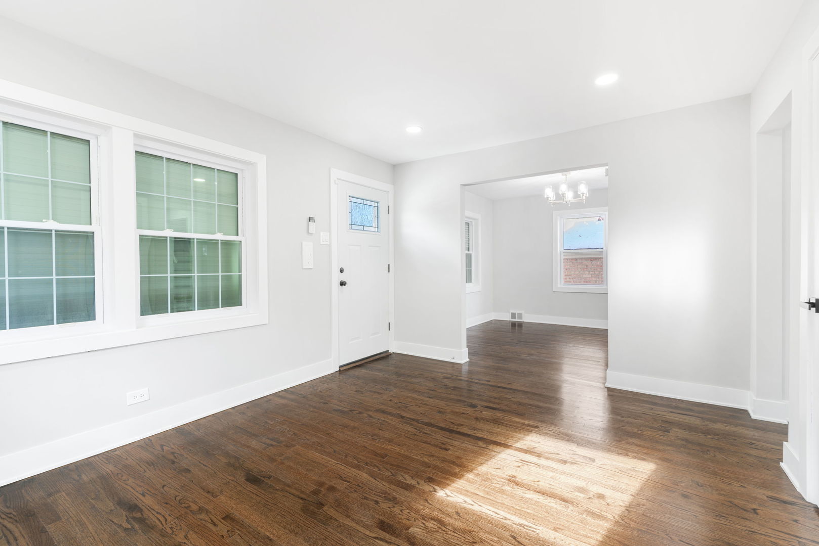 9633 South Yale Avenue Chicago, IL 60628 - Photo 6 of 26 a view of an empty room with wooden floor and a window