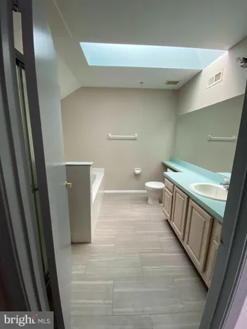 a view of a bathroom with toilet and a sink