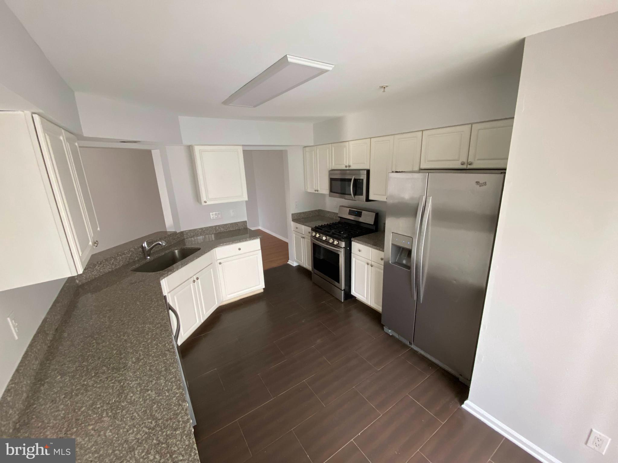 1408 Wharton Road Mount Laurel, NJ 08054 - Photo 5 of 23 a kitchen with stainless steel appliances a refrigerator and a stove top oven