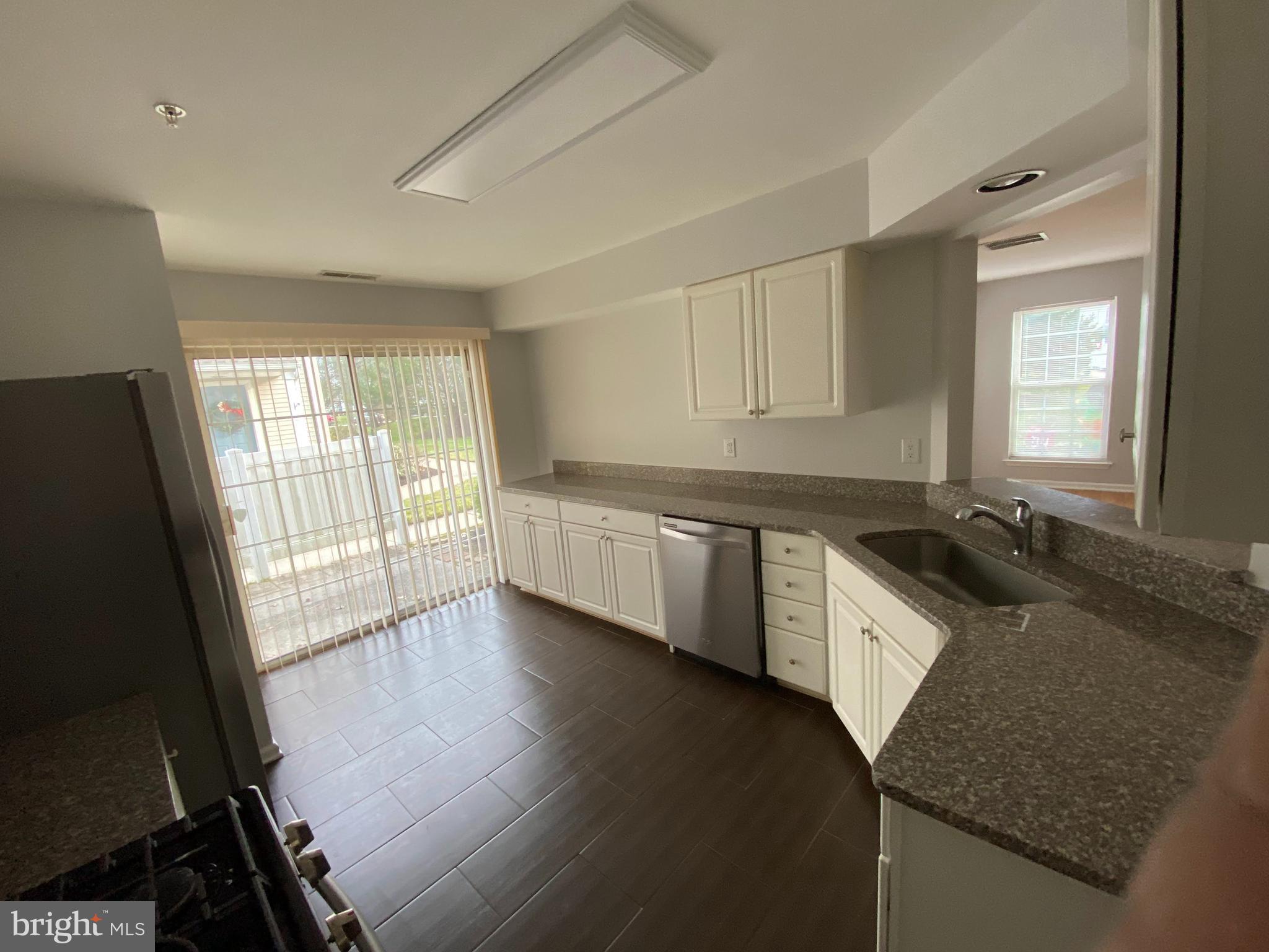 1408 Wharton Road Mount Laurel, NJ 08054 - Photo 7 of 23 a kitchen with granite countertop a stove a sink and a granite counter tops with white cabinets