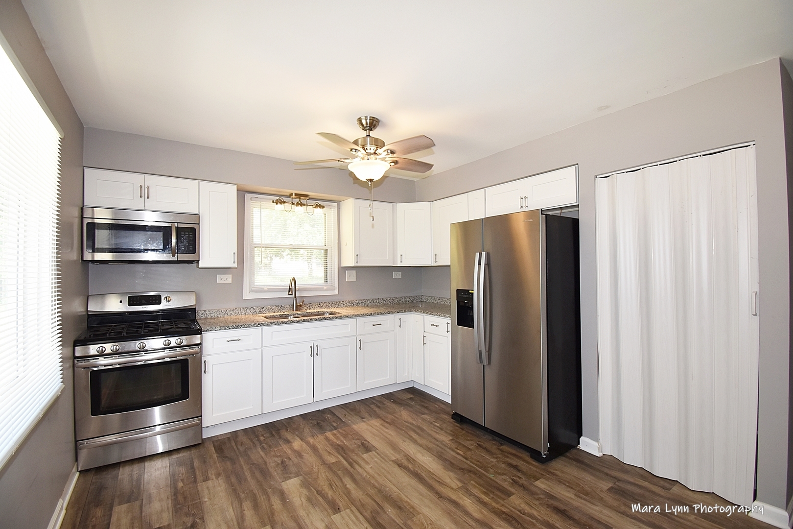 2413 Pecan Street Joliet, IL 60435 - Photo 2 of 14 a kitchen with stainless steel appliances a stove a sink and a refrigerator
