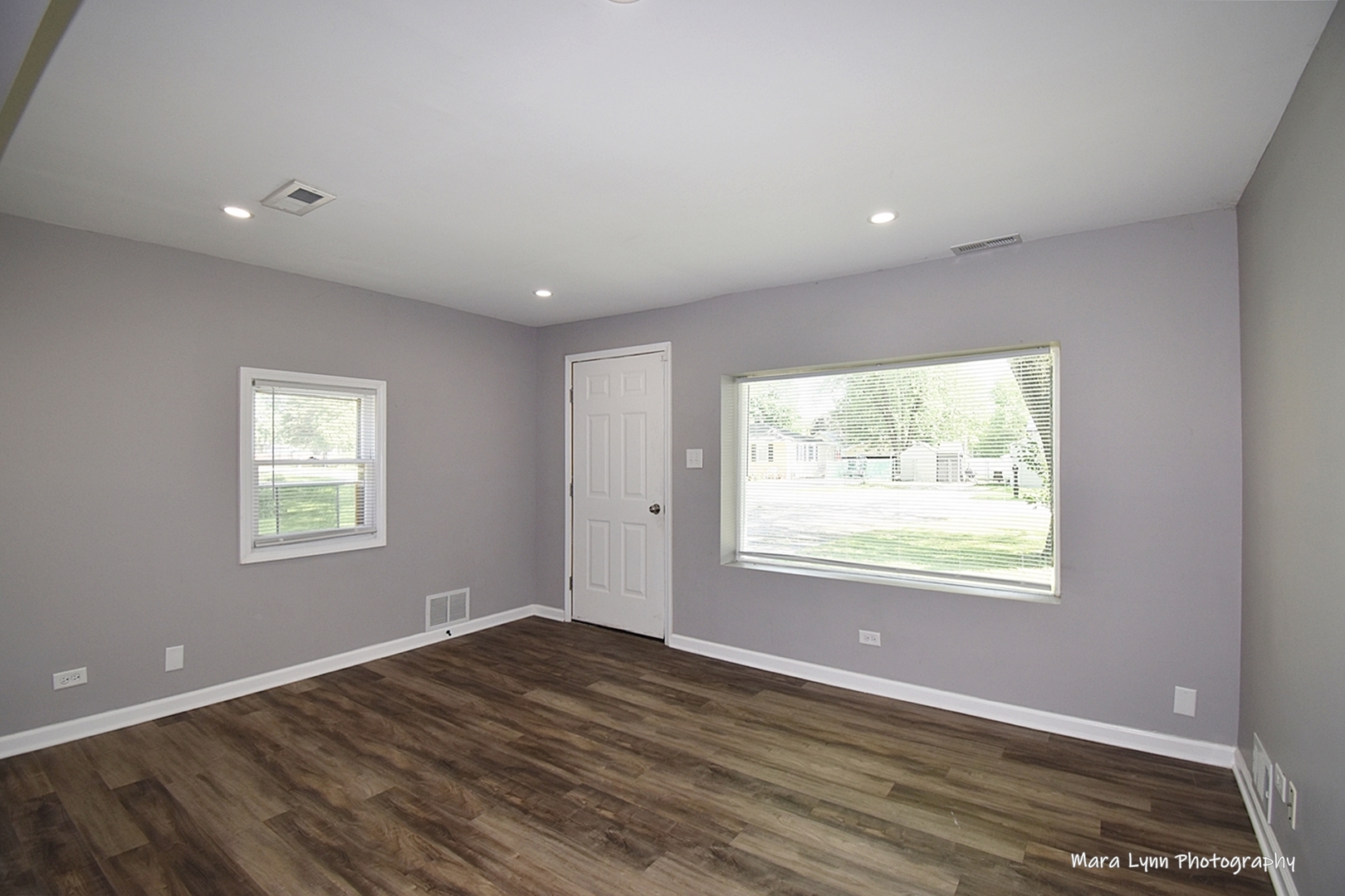2413 Pecan Street Joliet, IL 60435 - Photo 3 of 14 a view of an empty room with wooden floor and a window