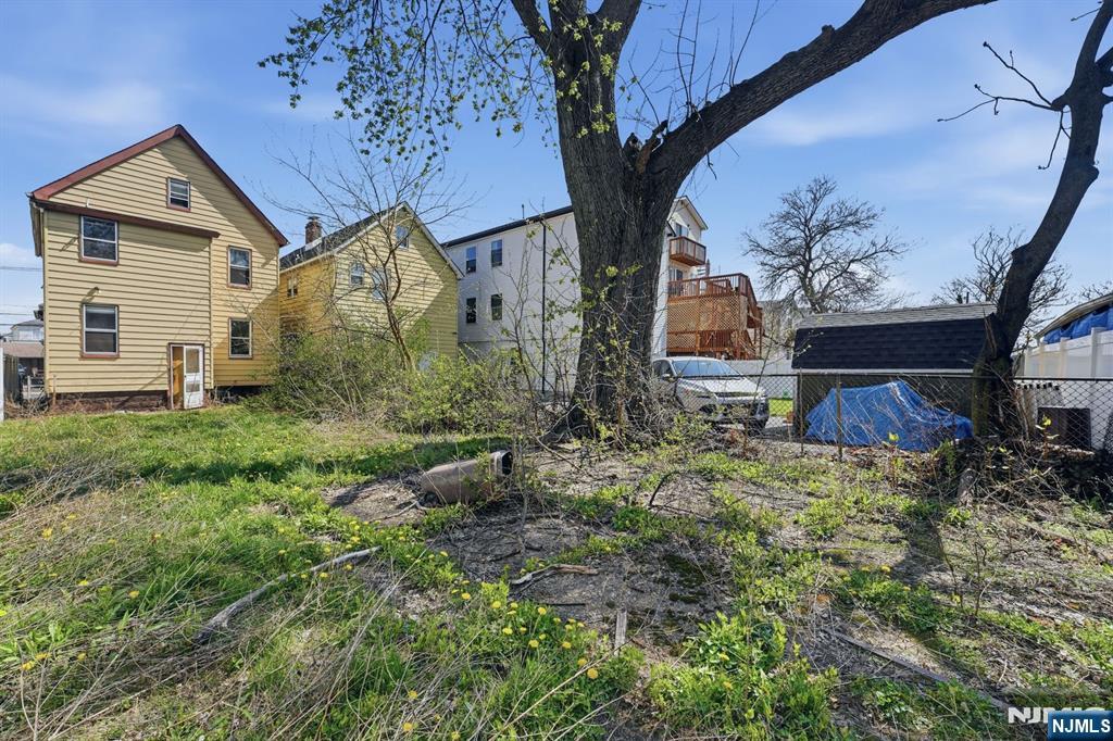 1024 Julia Street Elizabeth, NJ 07201 - Photo 23 of 30 a view of a house with a small yard and a large tree