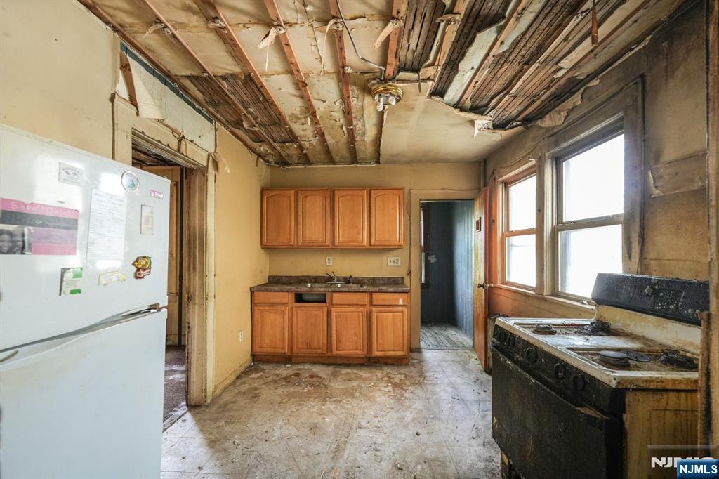 1024 Julia Street Elizabeth, NJ 07201 - Photo 27 of 30 a kitchen with stainless steel appliances granite countertop a stove a refrigerator a sink dishwasher and a stove