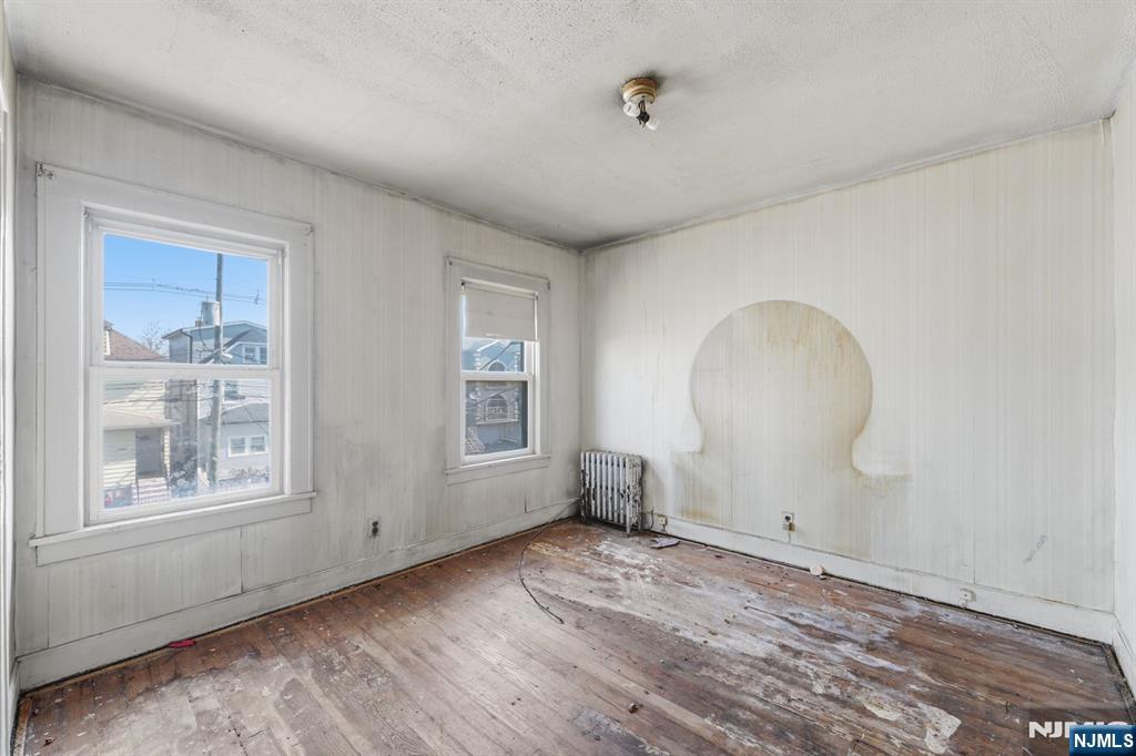 1024 Julia Street Elizabeth, NJ 07201 - Photo 4 of 30 a view of empty room with wooden floor and fan