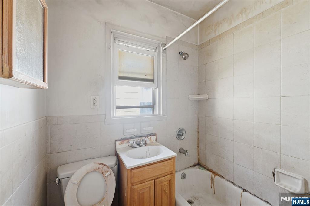 1024 Julia Street Elizabeth, NJ 07201 - Photo 9 of 30 a bathroom with a sink toilet vanity and shower