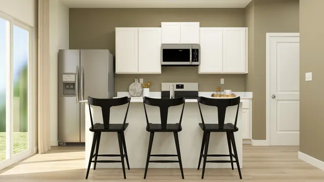 a kitchen with stainless steel appliances kitchen island granite countertop a refrigerator and microwave