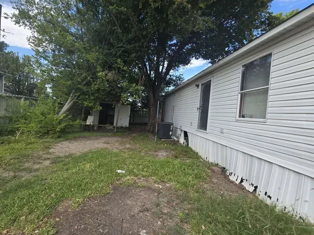 a view of a backyard with large trees