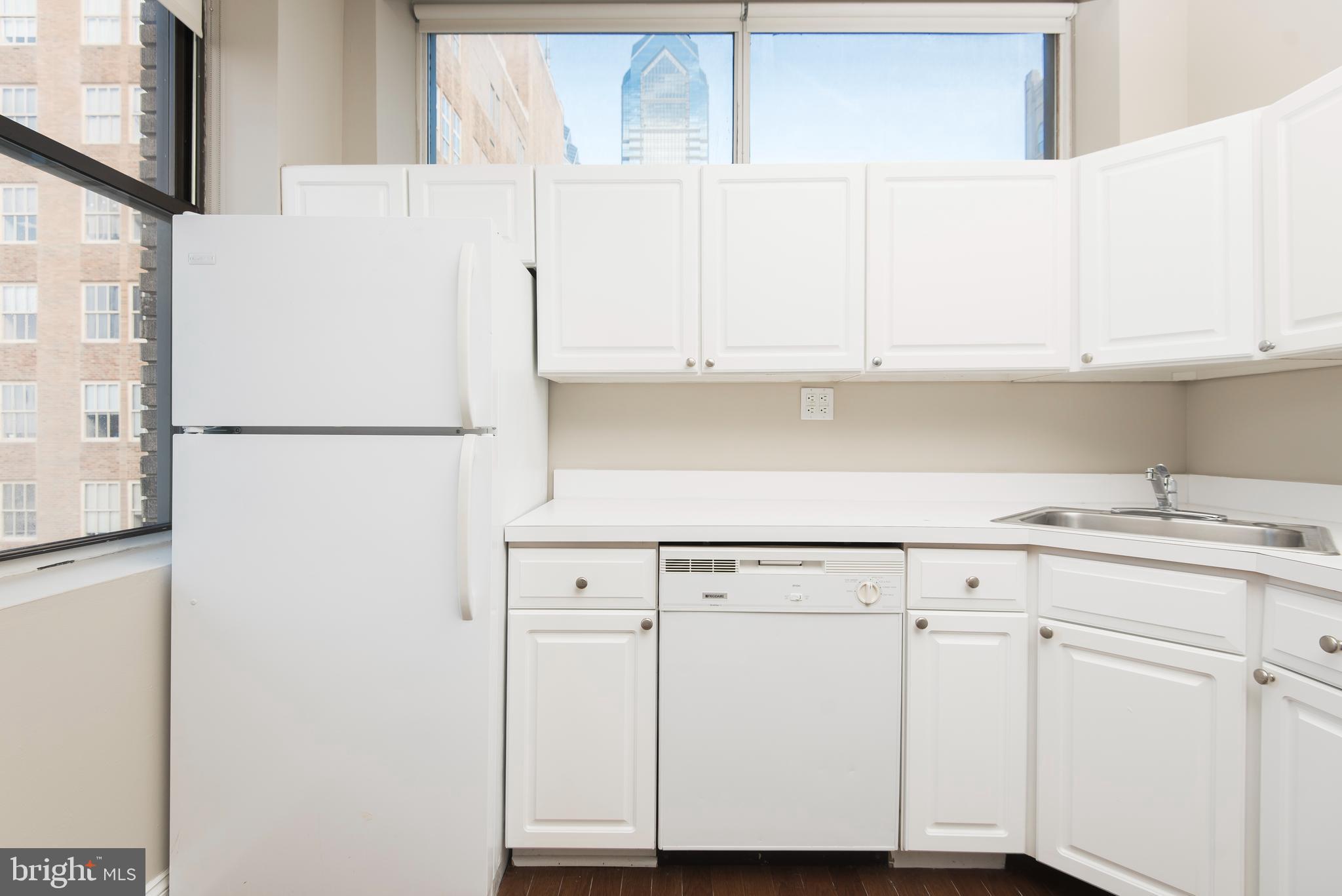 220 South 16th Street, Unit 1102 Philadelphia, PA 19102 - Photo 12 of 26 a white refrigerator freezer sitting inside of a kitchen