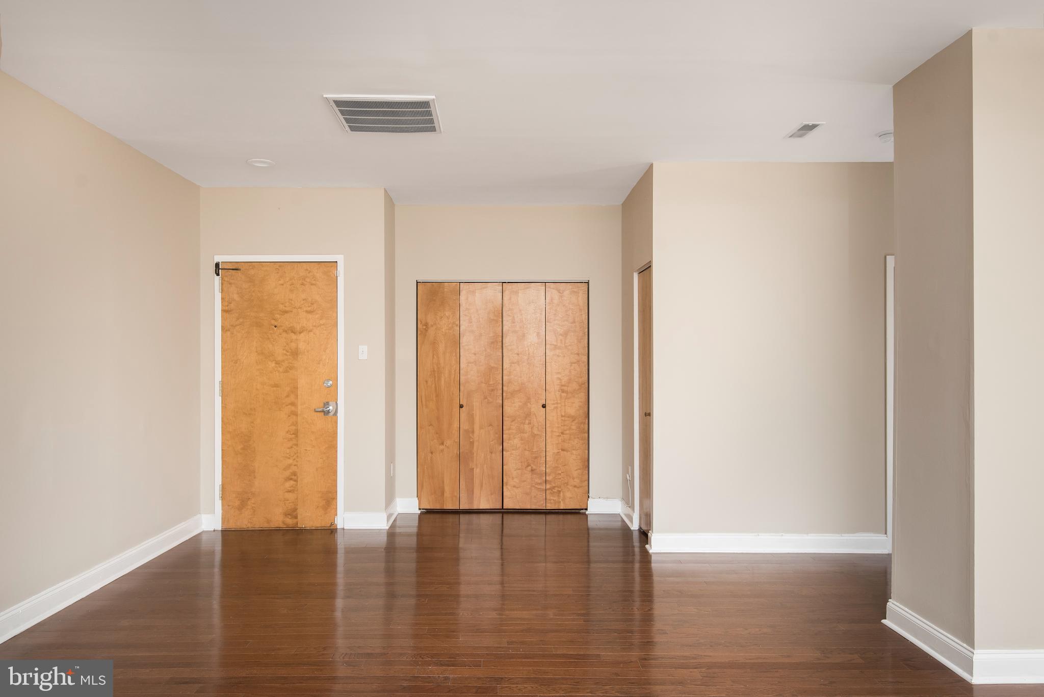 220 South 16th Street, Unit 1102 Philadelphia, PA 19102 - Photo 15 of 26 a view of an empty room with wooden floor and a window