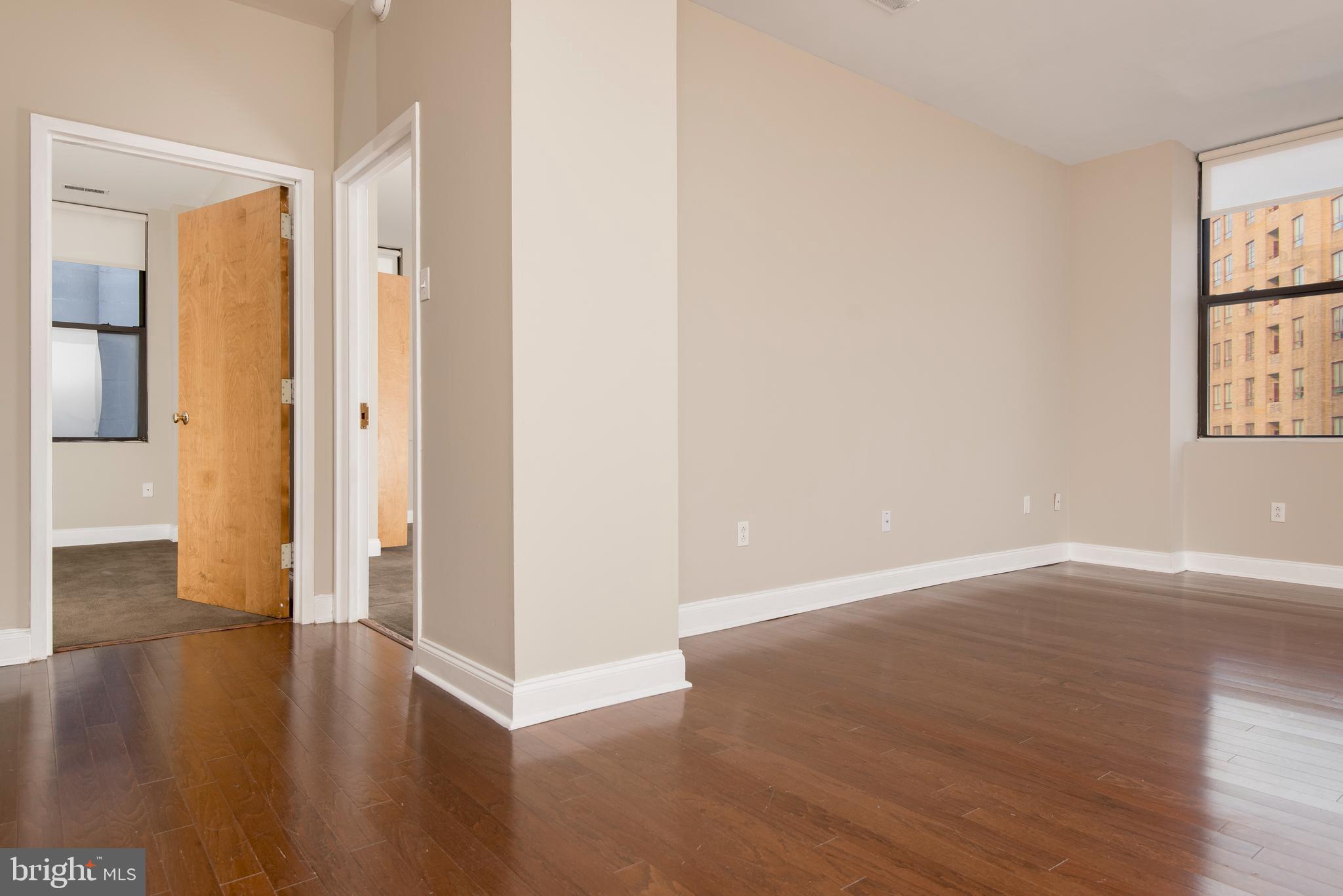 220 South 16th Street, Unit 1102 Philadelphia, PA 19102 - Photo 16 of 26 a view of an empty room with wooden floor and a window
