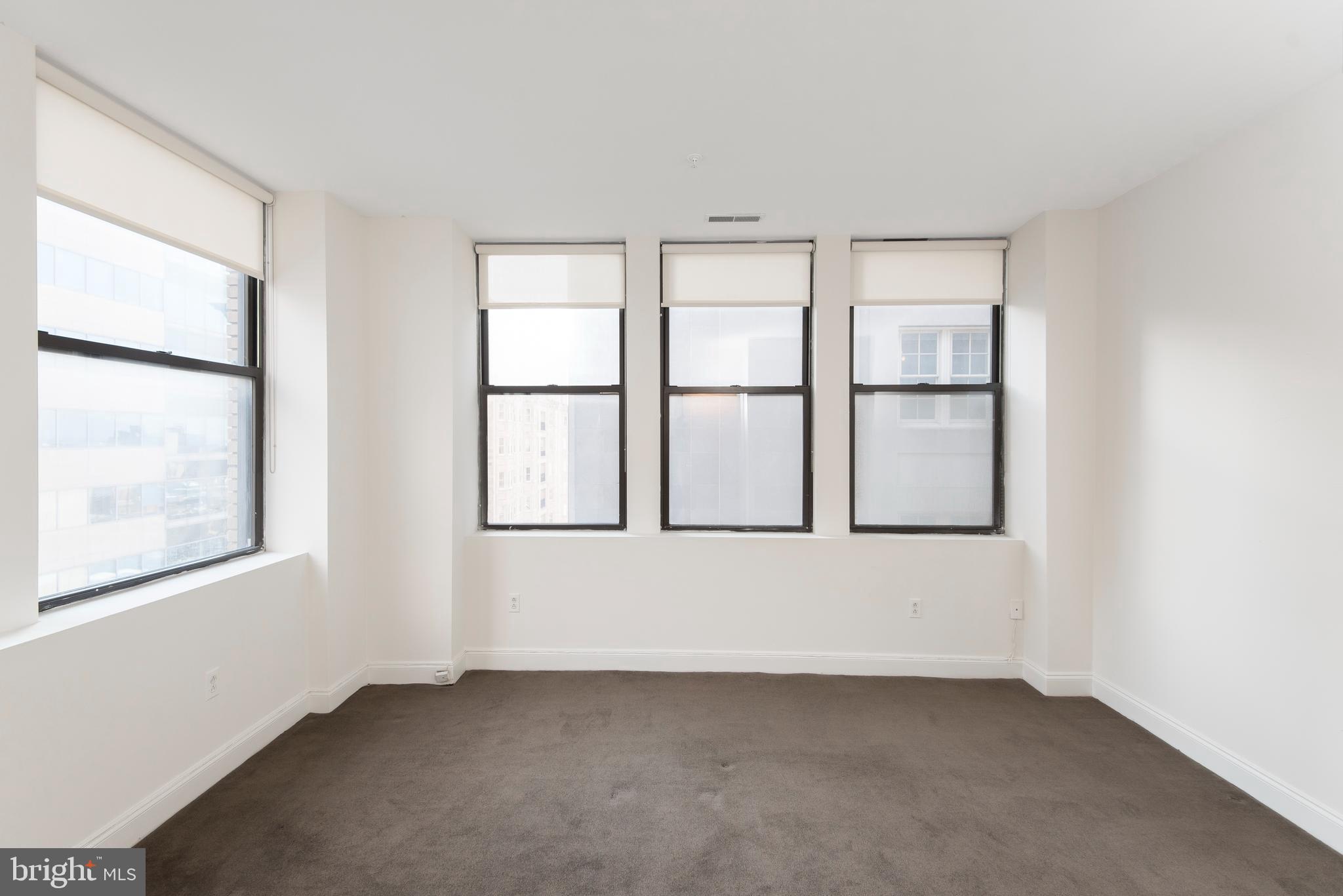 220 South 16th Street, Unit 1102 Philadelphia, PA 19102 - Photo 20 of 26 an empty room with windows and closet