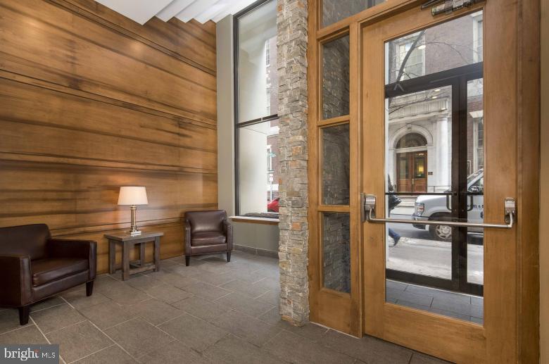 220 South 16th Street, Unit 1102 Philadelphia, PA 19102 - Photo 2 of 26 a view of a lobby with chair and glass door
