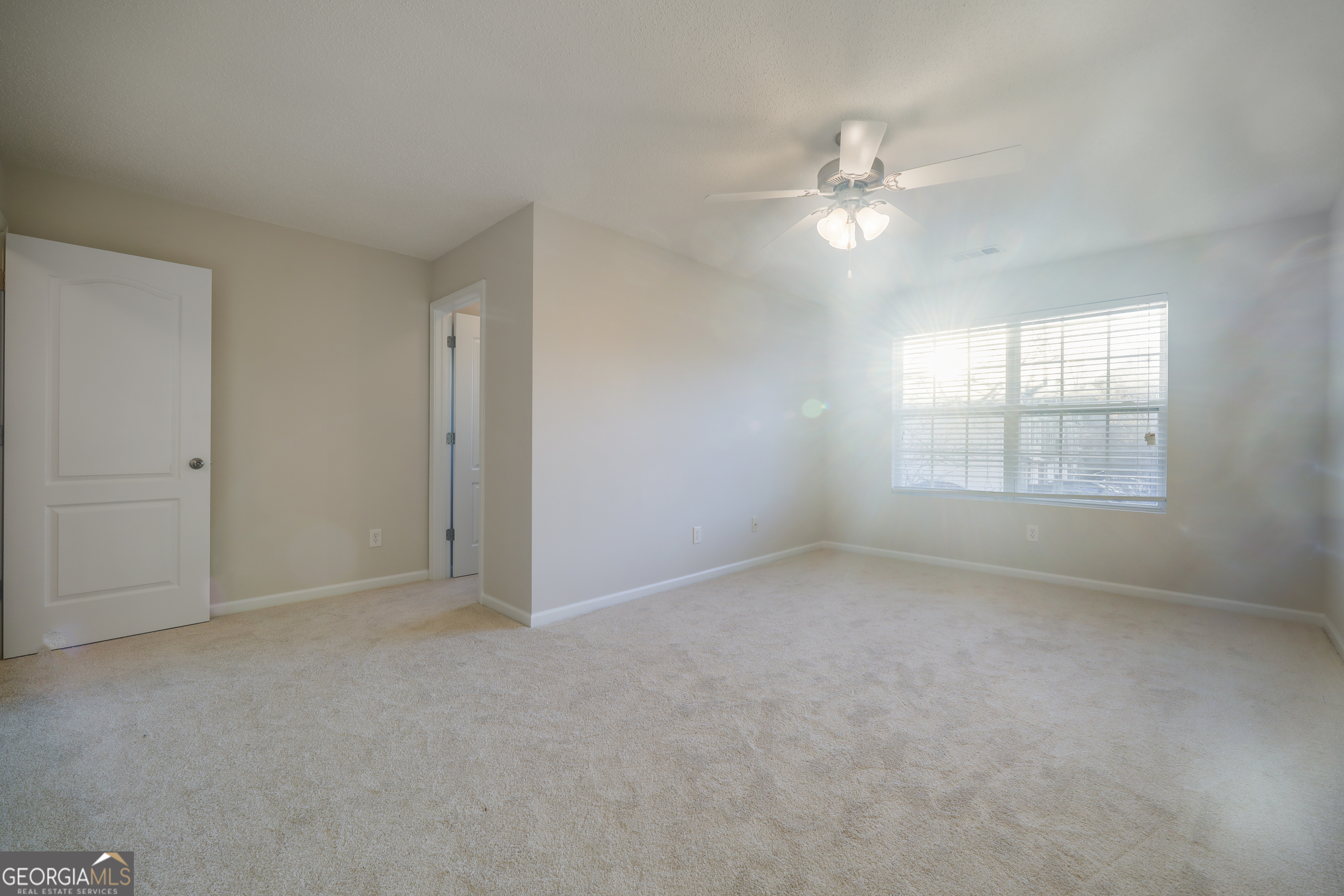 1442 Box Circle Winder, GA 30680 - Photo 12 of 25 an empty room with chandelier fan and windows