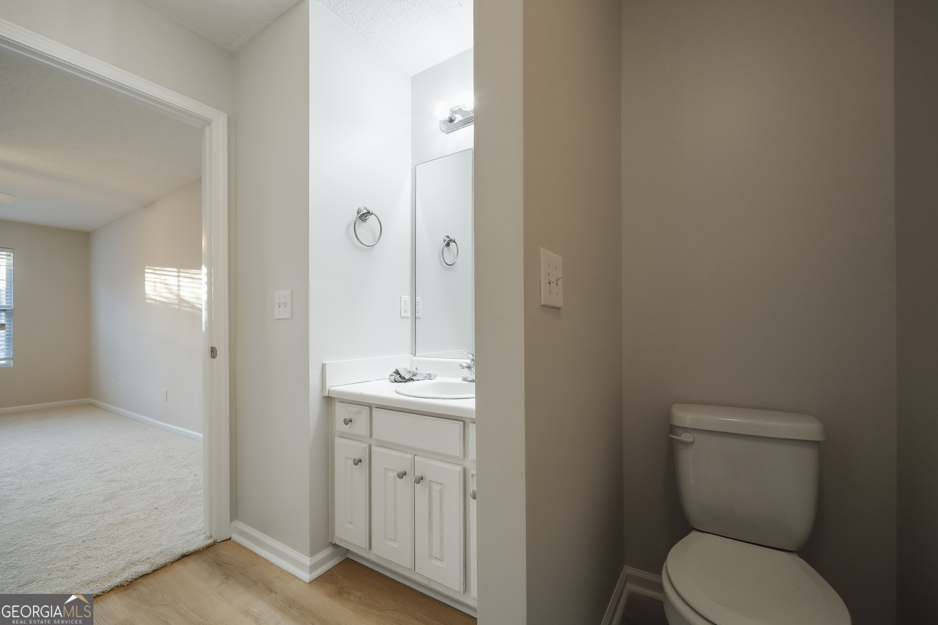 1442 Box Circle Winder, GA 30680 - Photo 17 of 25 a bathroom with a toilet a sink and mirror