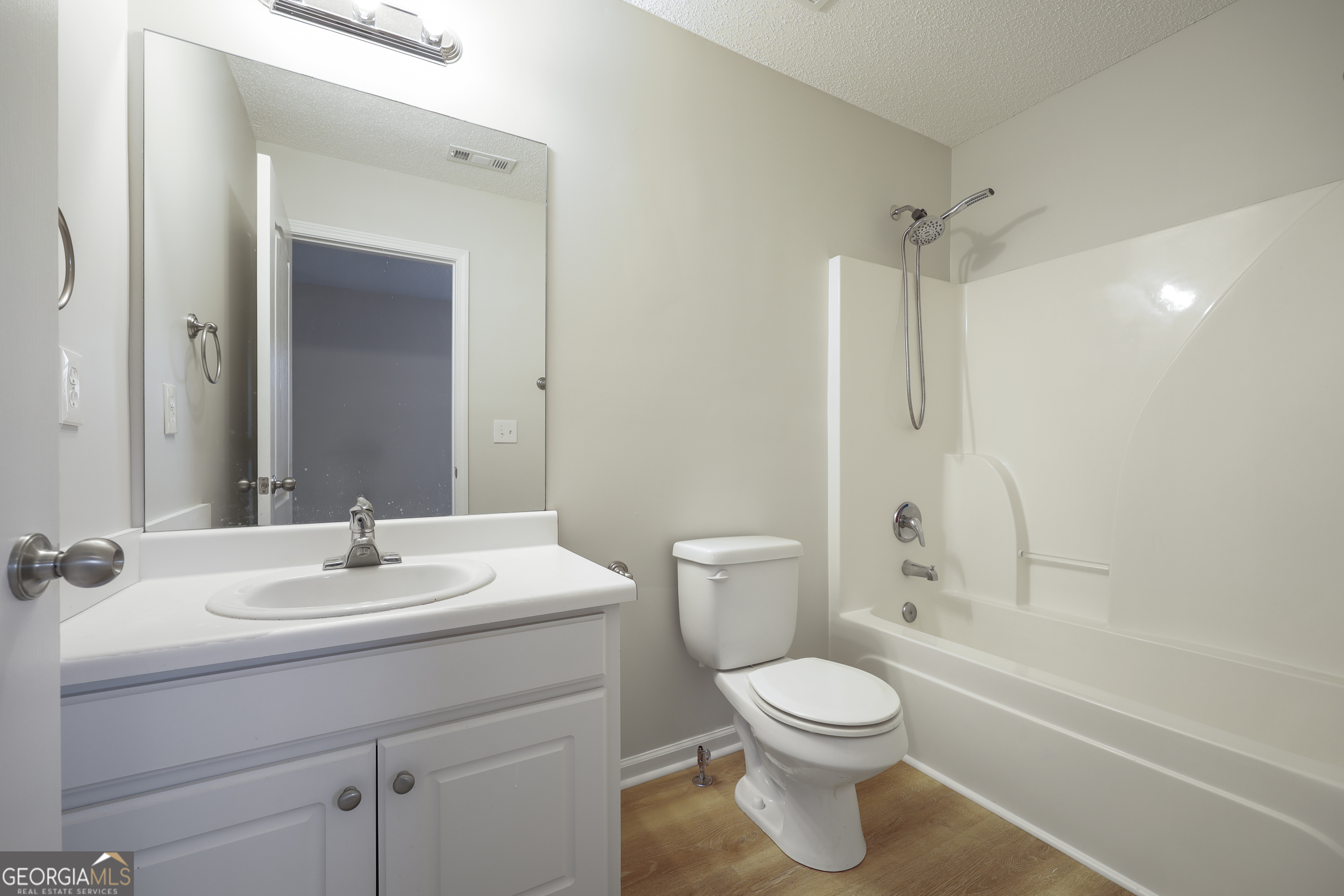 1442 Box Circle Winder, GA 30680 - Photo 20 of 25 a bathroom with a toilet sink vanity tub and shower