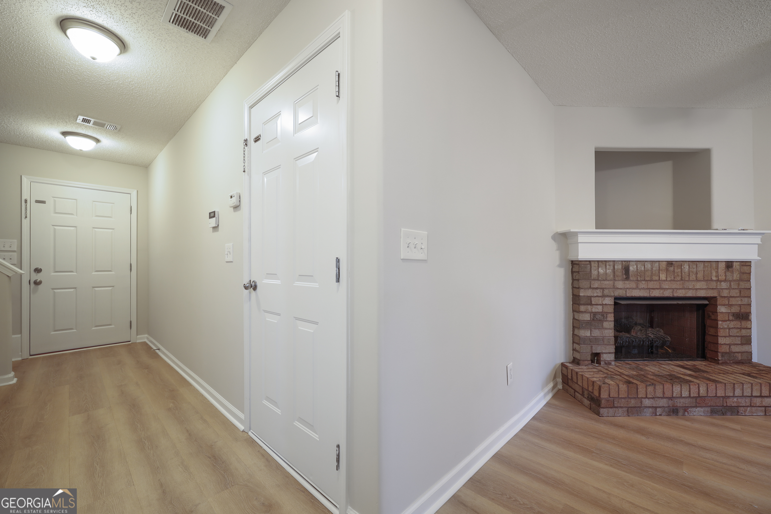 1442 Box Circle Winder, GA 30680 - Photo 3 of 25 a view of an empty room with wooden floor and a fireplace