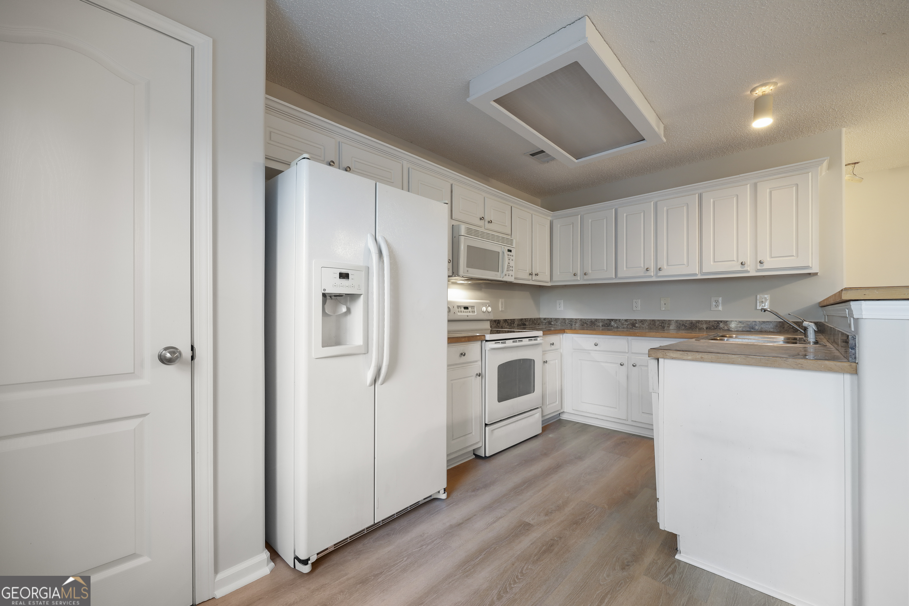 1442 Box Circle Winder, GA 30680 - Photo 5 of 25 a kitchen with white cabinets and white appliances