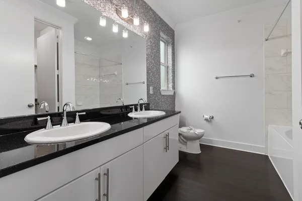 a bathroom with a double vanity sink and a mirror