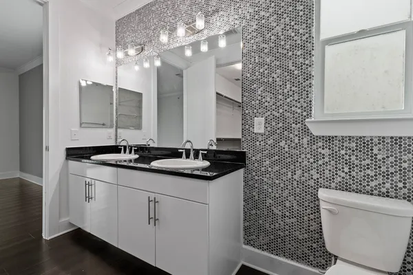 a bathroom with a toilet a sink and mirror