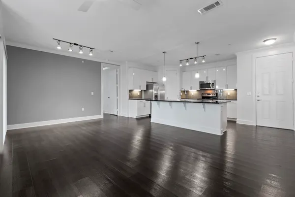 a view of a kitchen with a sink wooden floor and a window