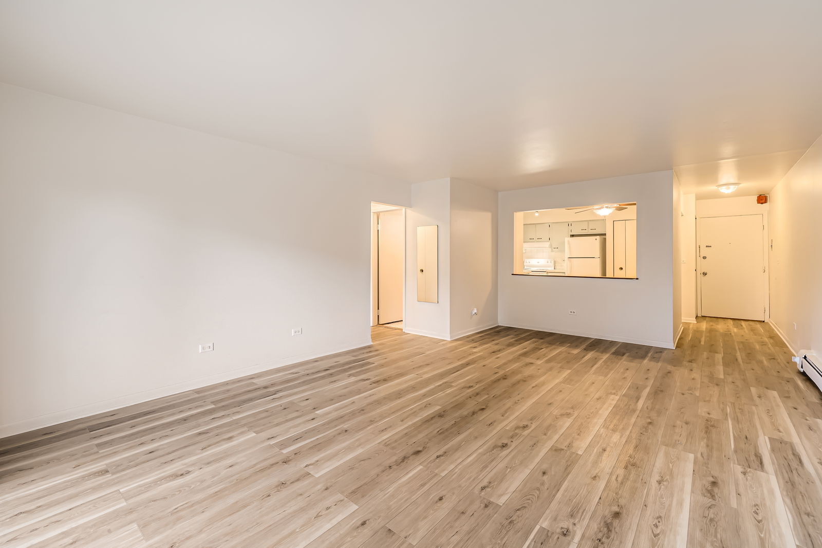2230 South Goebbert Road, Unit 147 Arlington Heights, IL 60005 - Photo 3 of 11 an empty room with wooden floor and windows