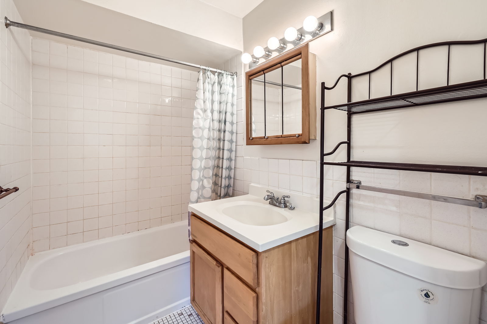 2230 South Goebbert Road, Unit 147 Arlington Heights, IL 60005 - Photo 9 of 11 a bathroom with a sink a toilet and shower