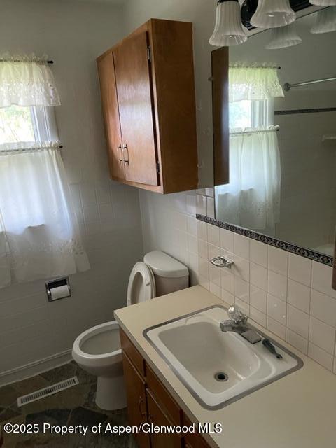 932 Ranney Street Craig, CO 81625 - Photo 13 of 23 a bathroom with a toilet sink and mirror