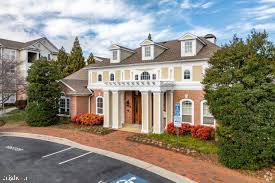 19609 Galway Bay Circle, Unit 303 Germantown, MD 20874 - Photo 22 of 22 a front view of a house with a yard and garage