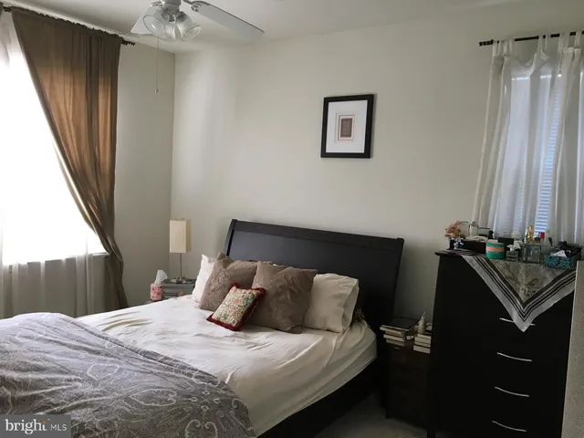 a bedroom with a bed and a mirror